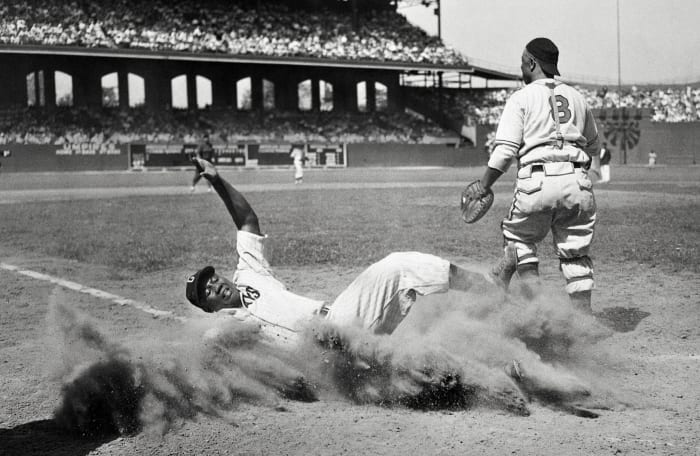 ELECTRIC SLIDE
Josh Gibson (crossing the plate during a Negro leagues All-Star Game in 1944) may well be the best power-hitting catcher—any league, any era. He was known as the Black Babe Ruth, though some who saw him play refer to the Bambino as the white Josh Gibson.